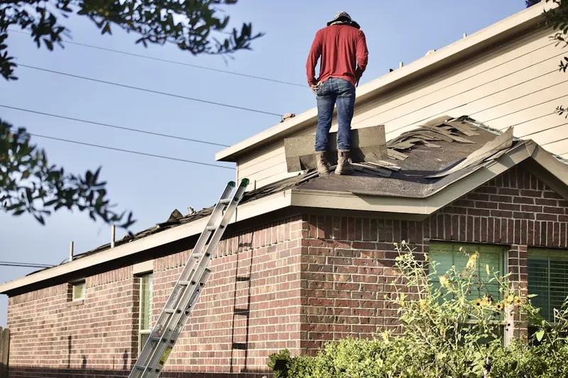 Professional roofer working on a residential roof in West Englewood